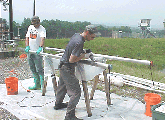 Opening the core barrel to retrieve sediment sample